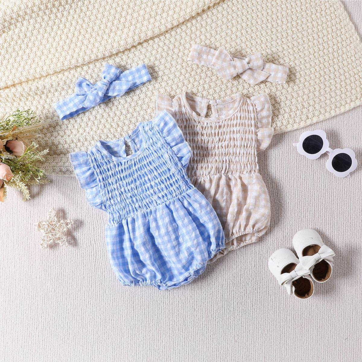 Baby girl sleeveless romper by Cozy Cub in solid blue with triangle design, featuring a comfortable bodysuit style.