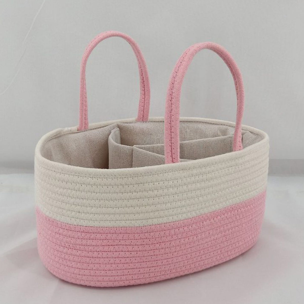 Cozy Cub Cotton Rope Diaper Caddy Organizer for nursery, featuring multiple compartments for baby essentials on a changing table.