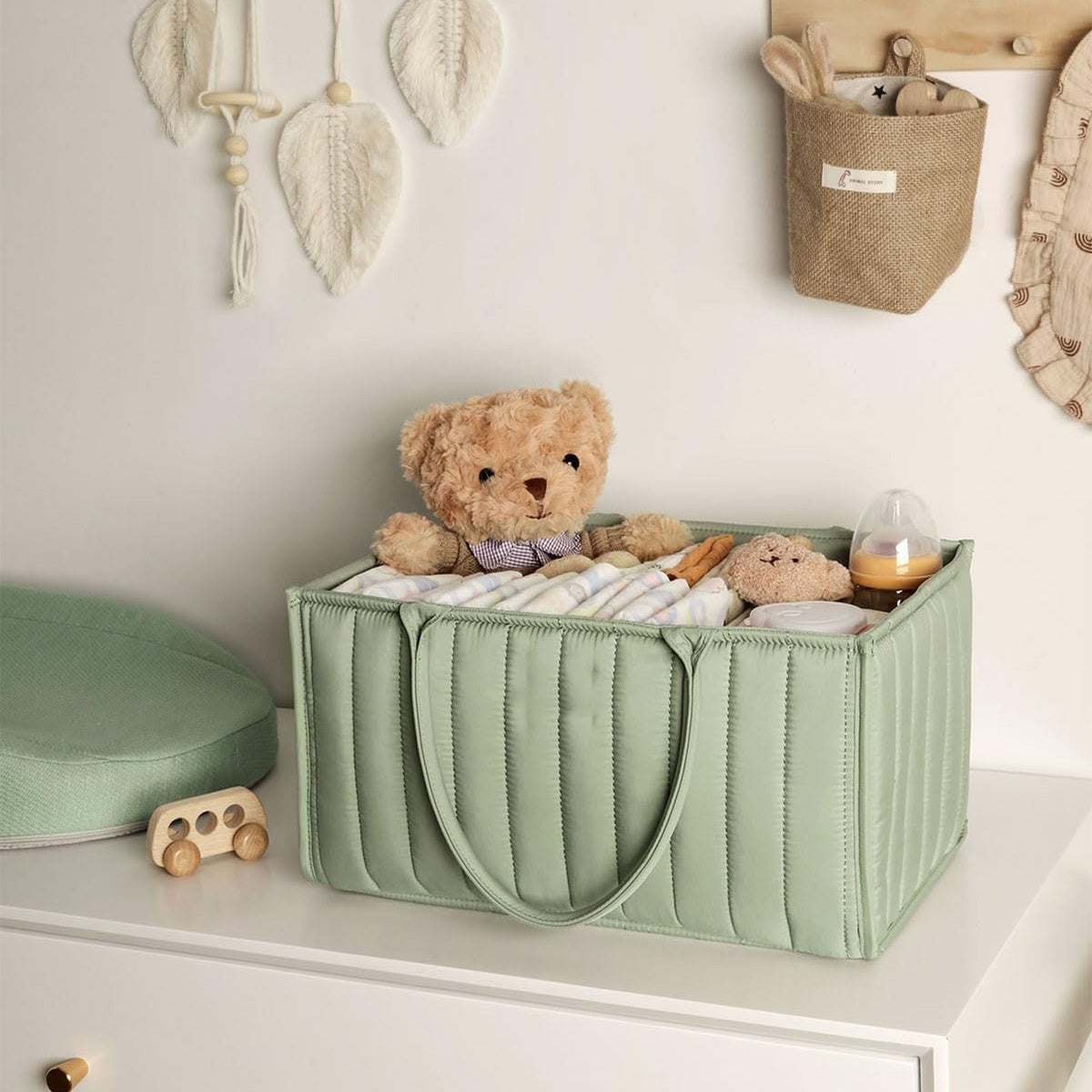 Green Cozy Cub Stylish Diaper Caddy Storage Basket, newborn essentials organizer with multiple compartments for easy diaper storage.