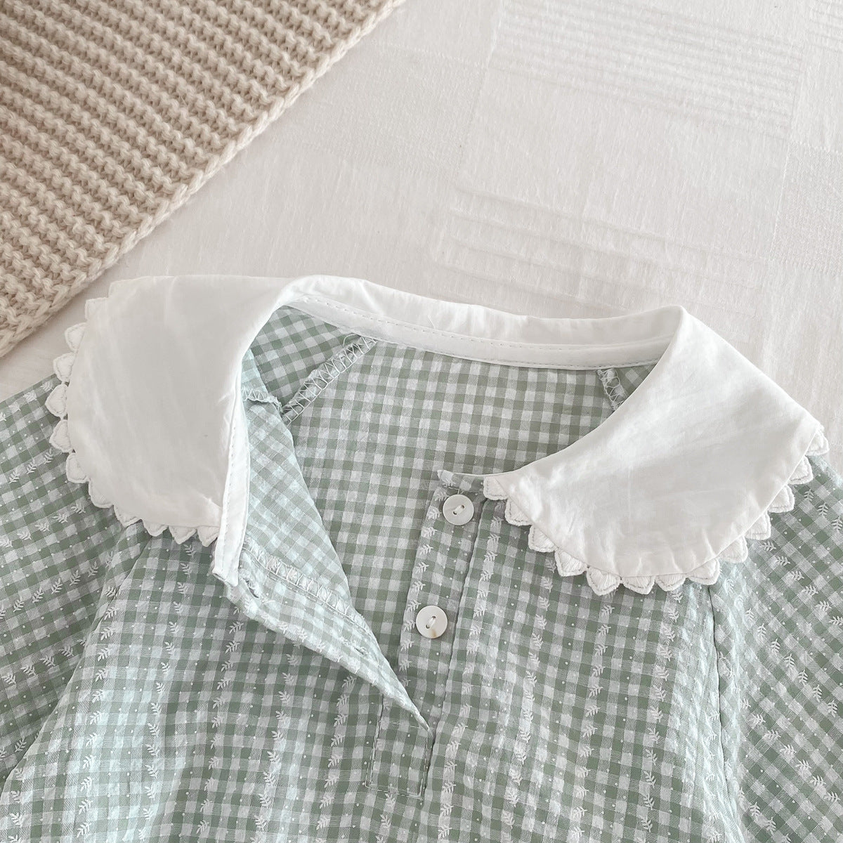Light green Cozy Cub baby girl doll romper with long sleeves and collar, designed as a one-piece outfit for infants.
