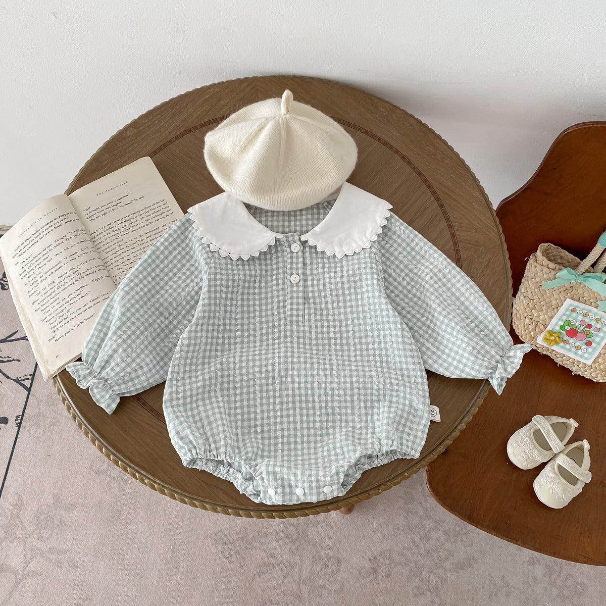 Light green Cozy Cub baby girl doll romper with long sleeves and collar, designed as a one-piece toddler apparel.