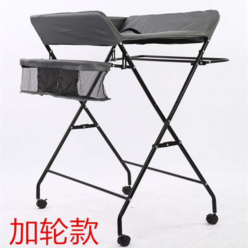 Dark grey Cozy Cub foldable baby diaper changing table, portable and compact baby furniture for convenient diaper changes.