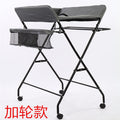 Dark grey Cozy Cub foldable baby diaper changing table, portable and compact baby furniture for convenient diaper changes.
