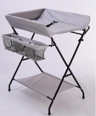 Dark grey Cozy Cub foldable baby diaper changing table, portable and compact baby furniture with padding and safety straps.
