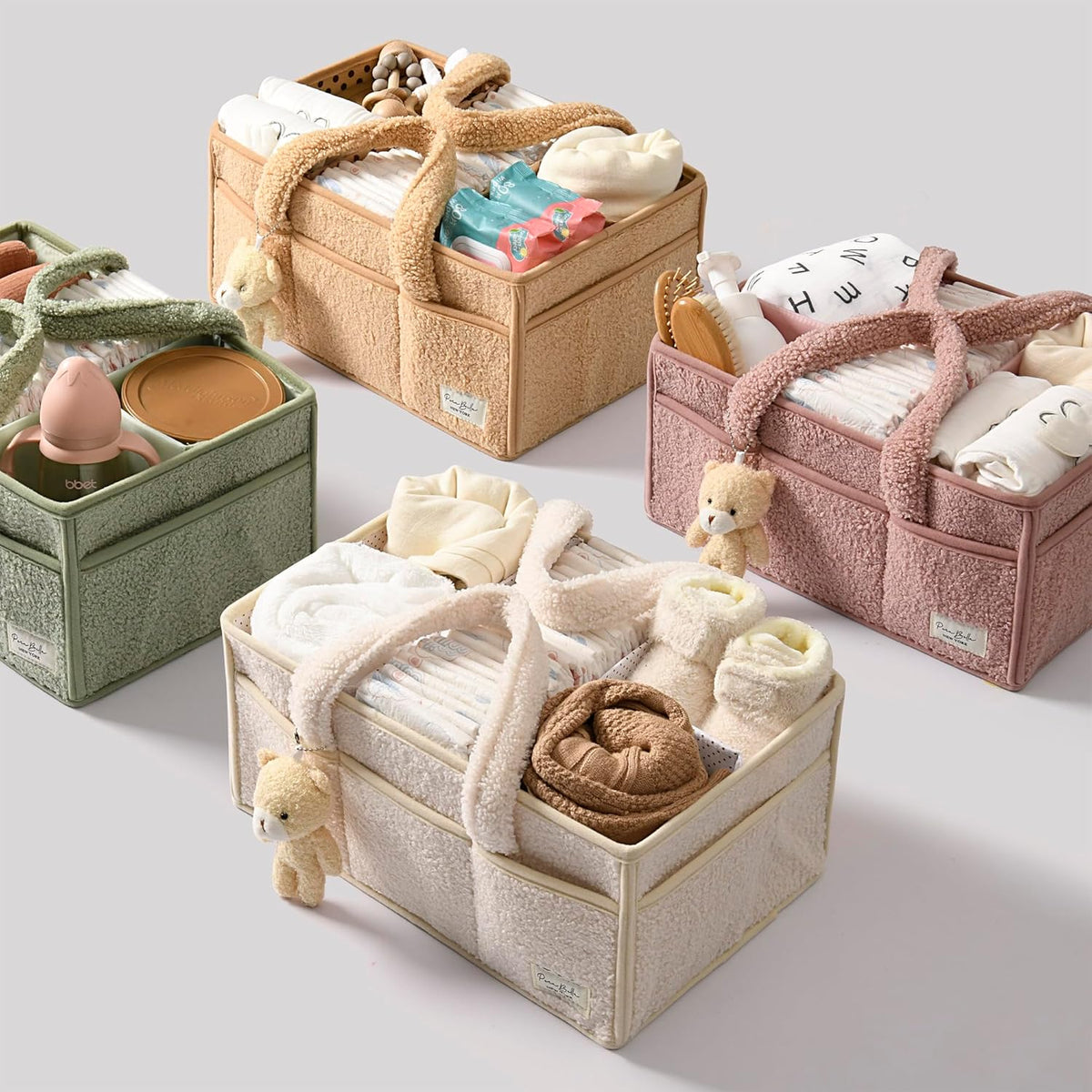 Green Cozy Cub diaper caddy organizer for nursery, with compartments for diaper accessories and changing table storage.