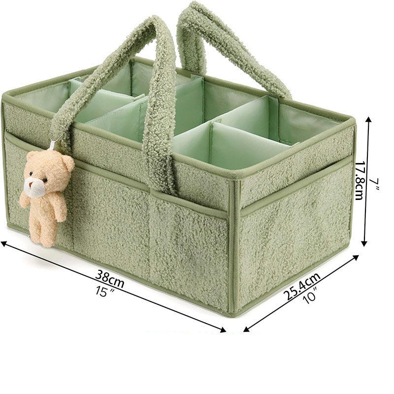 Green Cozy Cub diaper caddy organizer with multiple compartments for nursery changing table storage and diaper accessories.
