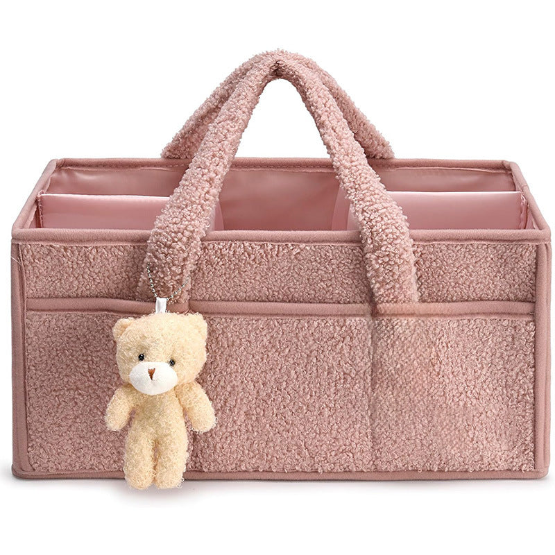 Green Cozy Cub diaper caddy organizer for nursery, with compartments for changing table storage and diaper accessories.