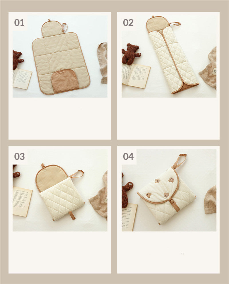 Cozy Cub portable baby diaper changing pad, foldable waterproof mat with bear design, ideal for on-the-go diaper changes.
