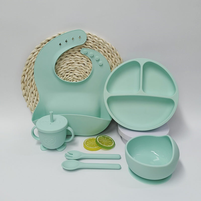 Beige Cozy Cub baby feeding set with silicone placemat and tableware, featuring suction cups for secure feeding.