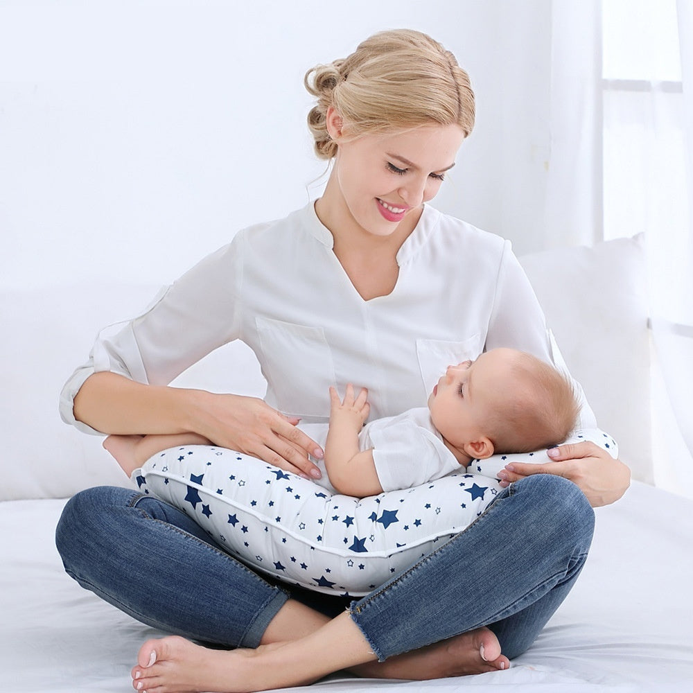 Blue Cozy Cub U-shape nursing pillow for breastfeeding support, designed for comfortable feeding for mothers.
