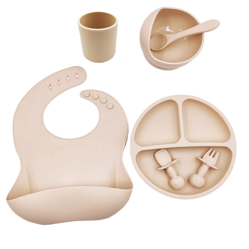 Cozy Cub baby feeding set with silicone bib, cup, and spoon in orange, designed for infants and toddlers.