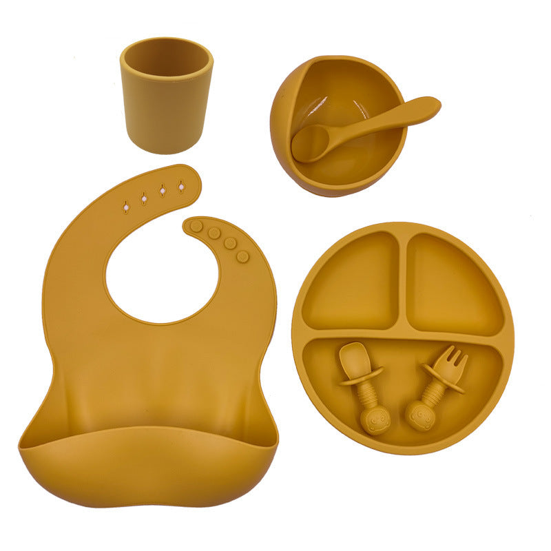 Cozy Cub baby feeding set with orange silicone bib, cup, and spoon for infants, designed for easy feeding and cleanup.