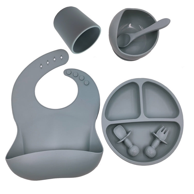 Cozy Cub baby feeding set with silicone bib, cup, and spoon, designed for toddler mealtime convenience and safety.