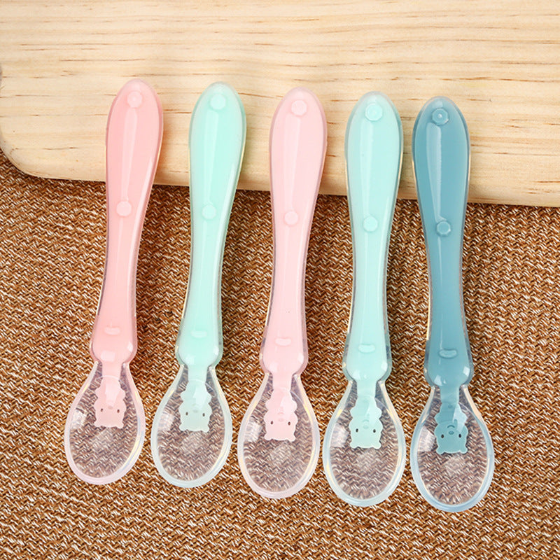 Pink Cozy Cub baby silicone spoon for infant feeding, soft and safe tableware designed for gentle feeding.