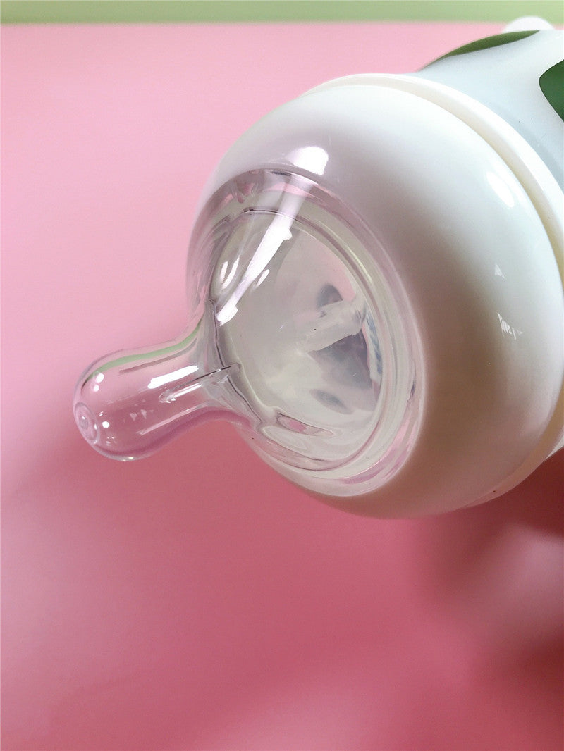 Pink Cozy Cub Wide Neck Baby Bottle made of soft silicone, designed for comfortable feeding for infants.