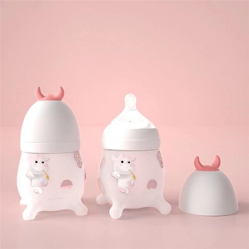 Cozy Cub Wide Neck Baby Bottle with soft silicone body, pink feeding bottle for infants, designed for easy feeding.
