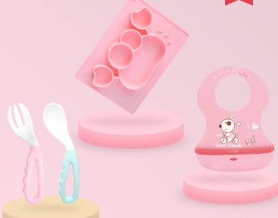 Pink Cozy Cub cartoon suction bowl made of silicone, designed for infant feeding, featuring a playful cartoon character on the dish.