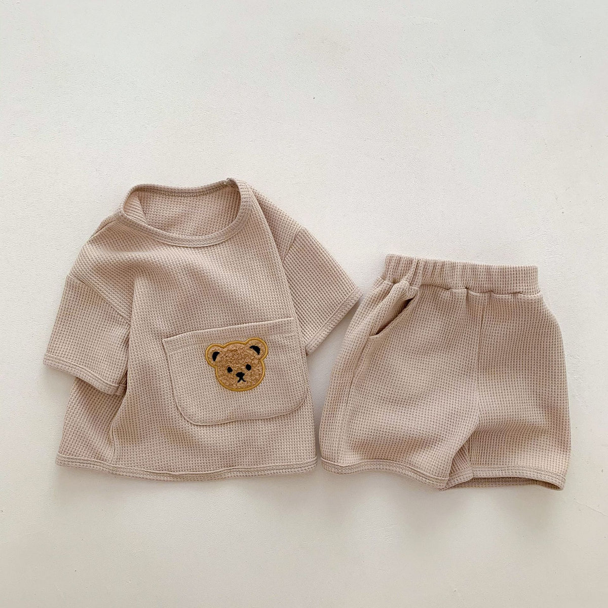 Ivory white waffle knit set with bear print top and matching shorts by eprolo, perfect for cozy casual wear.